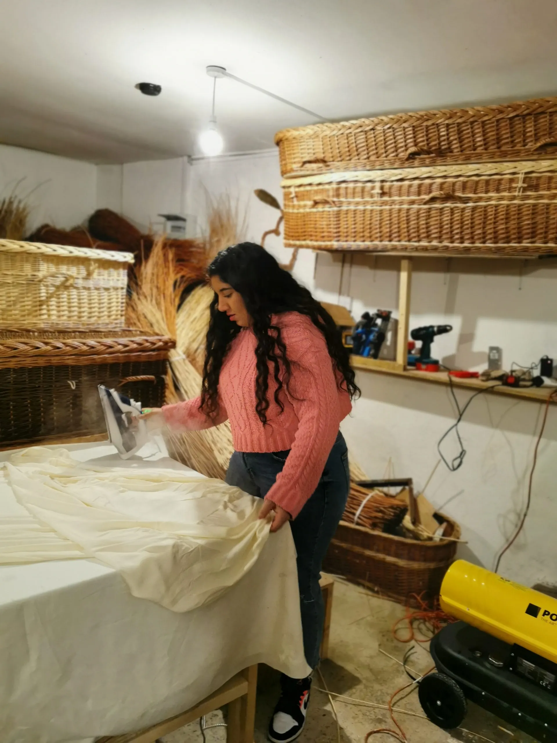 A liner being sewn for a willow coffin